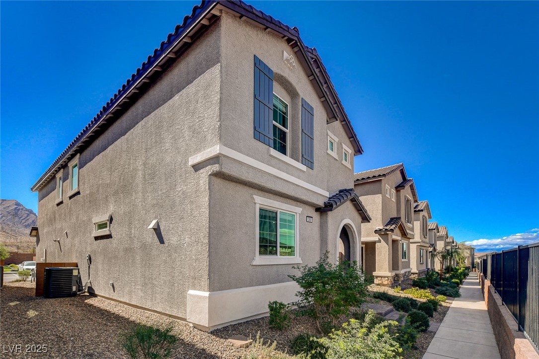 1360 Cerulean Avenue Henderson, NV 89002 - Photo 2 of 62 View of side of home featuring stucco siding and a tiled roof