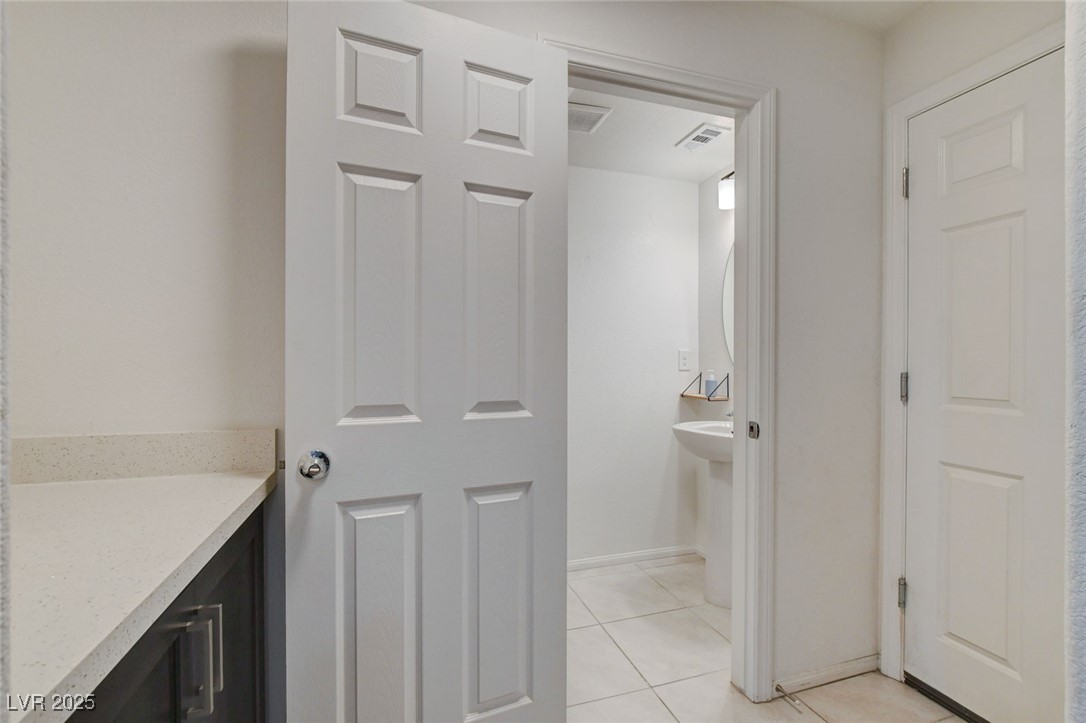 1360 Cerulean Avenue Henderson, NV 89002 - Photo 23 of 62 Half bath with light tile patterned floors and baseboards