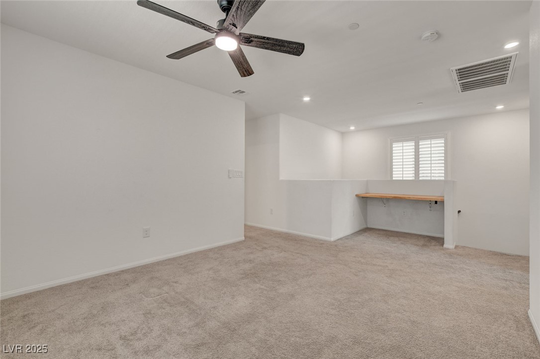 1360 Cerulean Avenue Henderson, NV 89002 - Photo 29 of 62 Unfurnished room with light colored carpet, a desk, ceiling fan, and recessed lighting