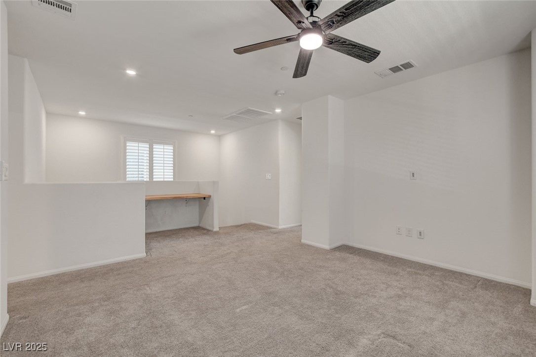 1360 Cerulean Avenue Henderson, NV 89002 - Photo 30 of 62 Empty room featuring light carpet, recessed lighting, ceiling fan, and built in study area