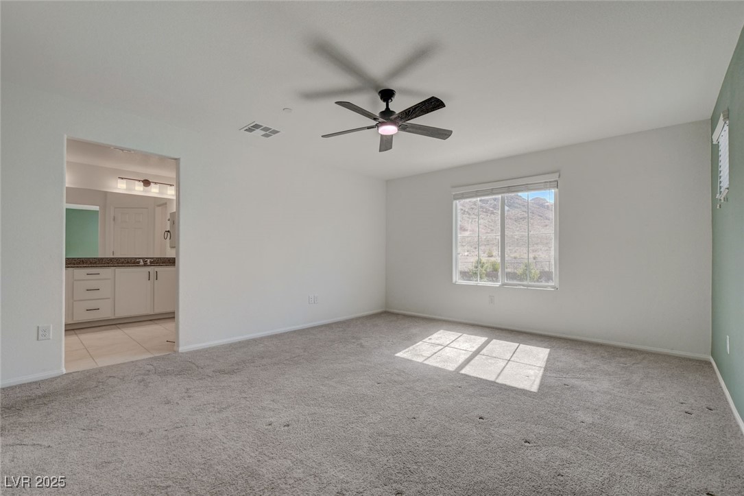 1360 Cerulean Avenue Henderson, NV 89002 - Photo 35 of 62 Unfurnished bedroom featuring light colored carpet, a ceiling fan, and ensuite bath