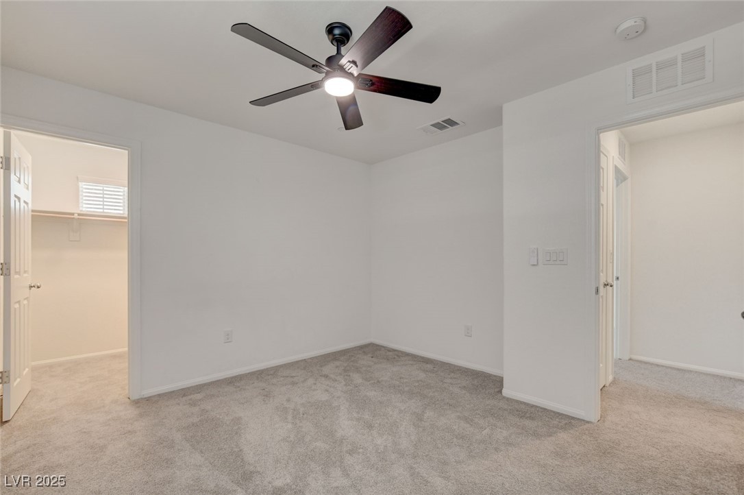 1360 Cerulean Avenue Henderson, NV 89002 - Photo 44 of 62 Unfurnished bedroom with light colored carpet, a walk in closet, and ceiling fan
