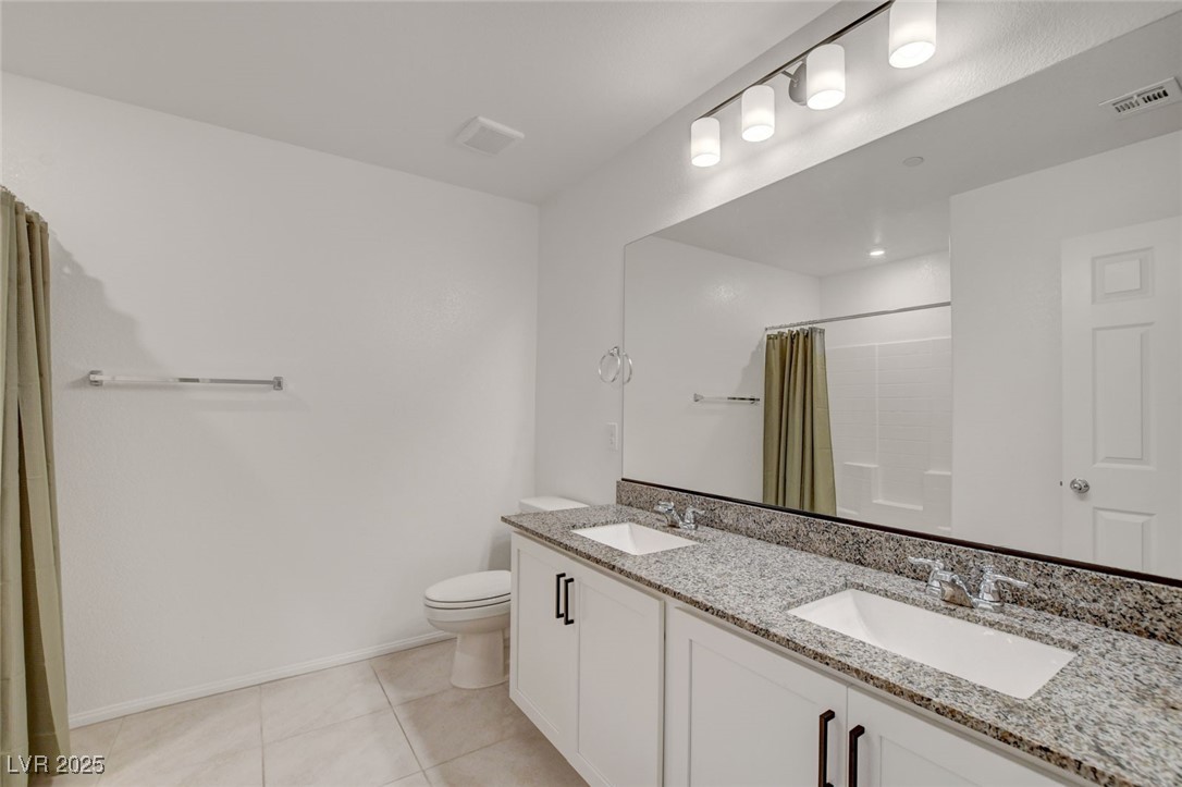 1360 Cerulean Avenue Henderson, NV 89002 - Photo 49 of 62 Full bath with double vanity, light tile patterned floors, and a shower with curtain