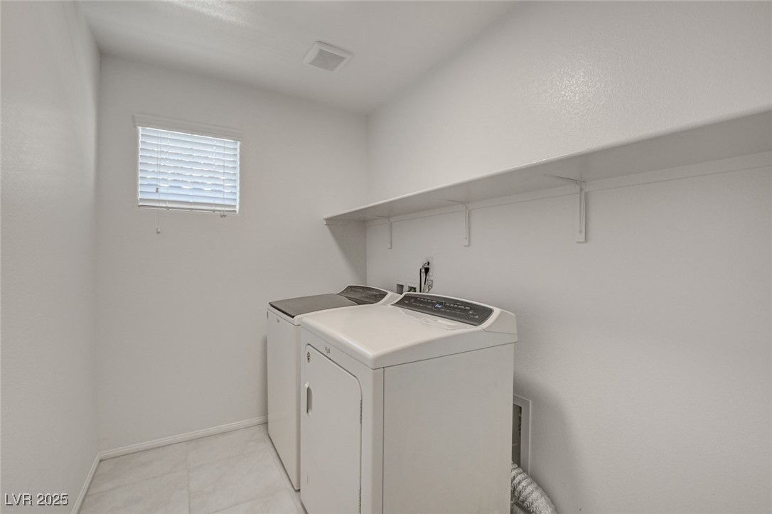 1360 Cerulean Avenue Henderson, NV 89002 - Photo 51 of 62 Washroom with washer and clothes dryer and light tile patterned floors