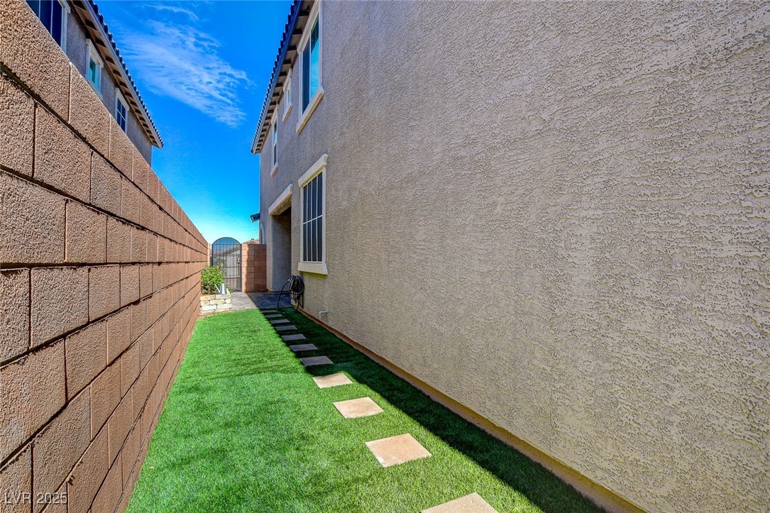1360 Cerulean Avenue Henderson, NV 89002 - Photo 57 of 62 View of property exterior featuring stucco siding