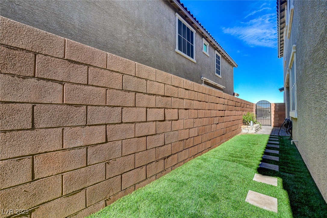 1360 Cerulean Avenue Henderson, NV 89002 - Photo 58 of 62 View of home's exterior featuring stucco siding and a gate
