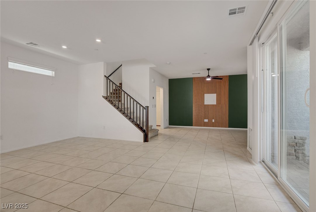 1360 Cerulean Avenue Henderson, NV 89002 - Photo 6 of 62 Unfurnished room with stairs, a ceiling fan, light tile patterned floors, wood walls, and recessed lighting