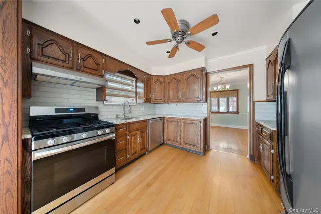 a kitchen with stainless steel appliances granite countertop a stove and a refrigerator