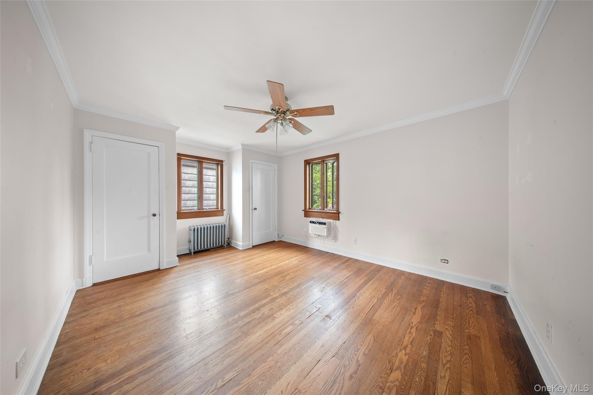 47-69 195th Street Queens, NY 11358 - Photo 6 of 12 an empty room with windows and closet