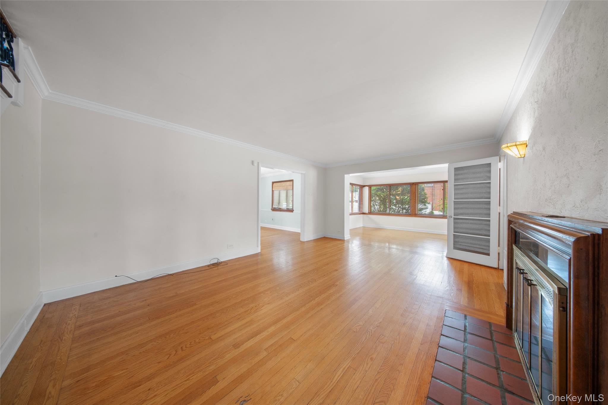 47-69 195th Street Queens, NY 11358 - Photo 8 of 12 a view of empty room with wooden floor and fan
