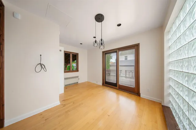 a view of an empty room with window and cabinet