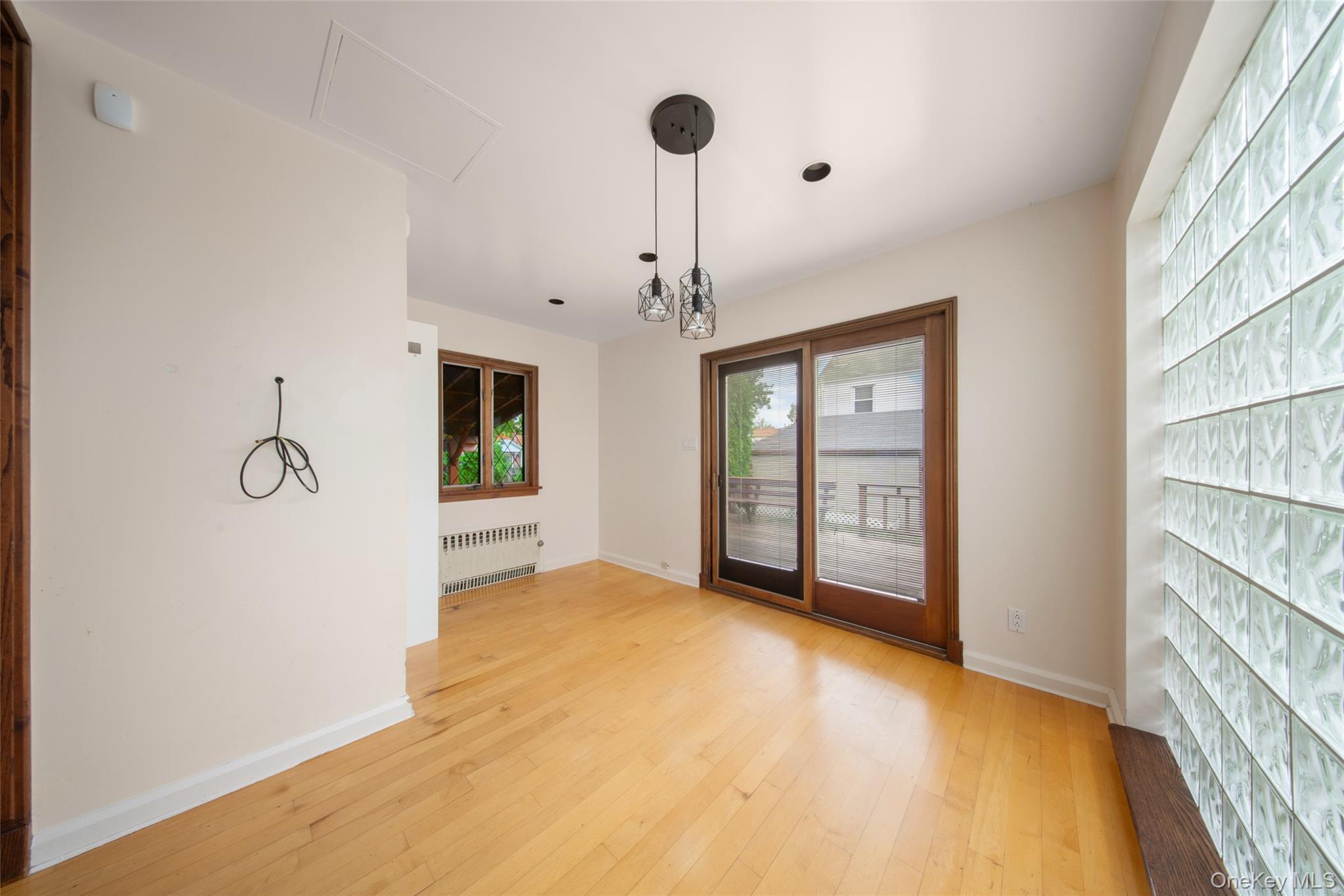 47-69 195th Street Queens, NY 11358 - Photo 9 of 12 a view of an empty room with window and cabinet