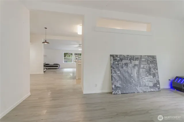 a view of a livingroom with wooden floor and a cabinet