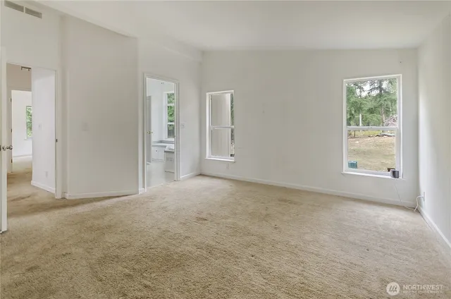 an empty room with windows and closet