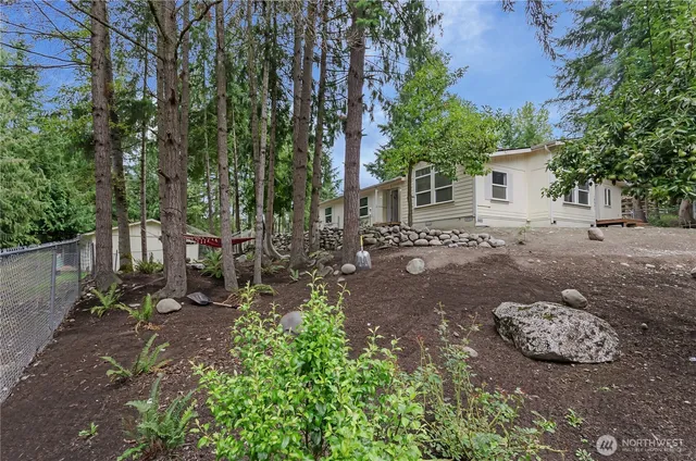 a view of a backyard with table and chairs and potted plants