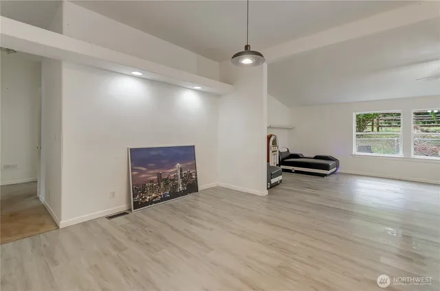 a view of empty room with wooden floor