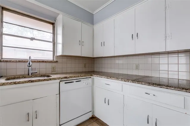 a kitchen with granite countertop white cabinets and white appliances
