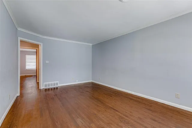 a view of an empty room and wooden floor