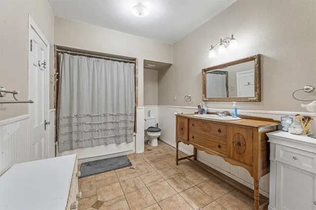 a spacious bathroom with a granite countertop sink a mirror and a