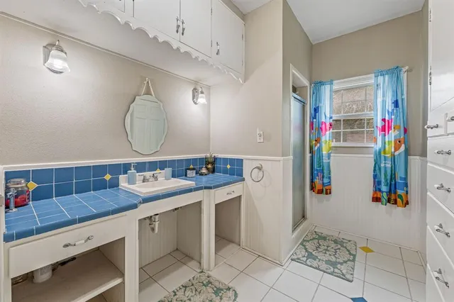 a bathroom with a sink mirror and vanity