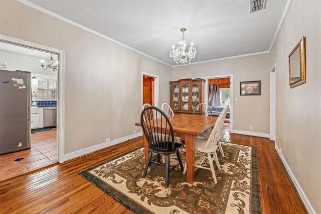 a view of a dining room with furniture wooden floor and chandelier