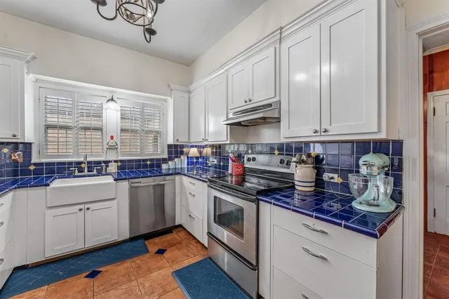 a kitchen with stainless steel appliances granite countertop a sink and cabinets