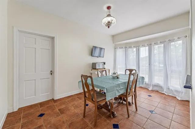 a view of a dining room with furniture and a window