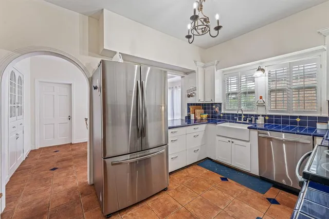 a kitchen with stainless steel appliances granite countertop a refrigerator sink and cabinets
