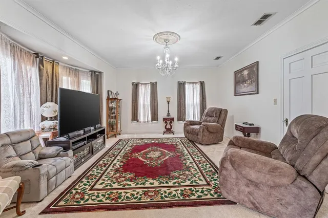 a living room with furniture a rug and a flat screen tv