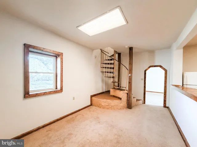 a white toilet sitting next to a white cabinet