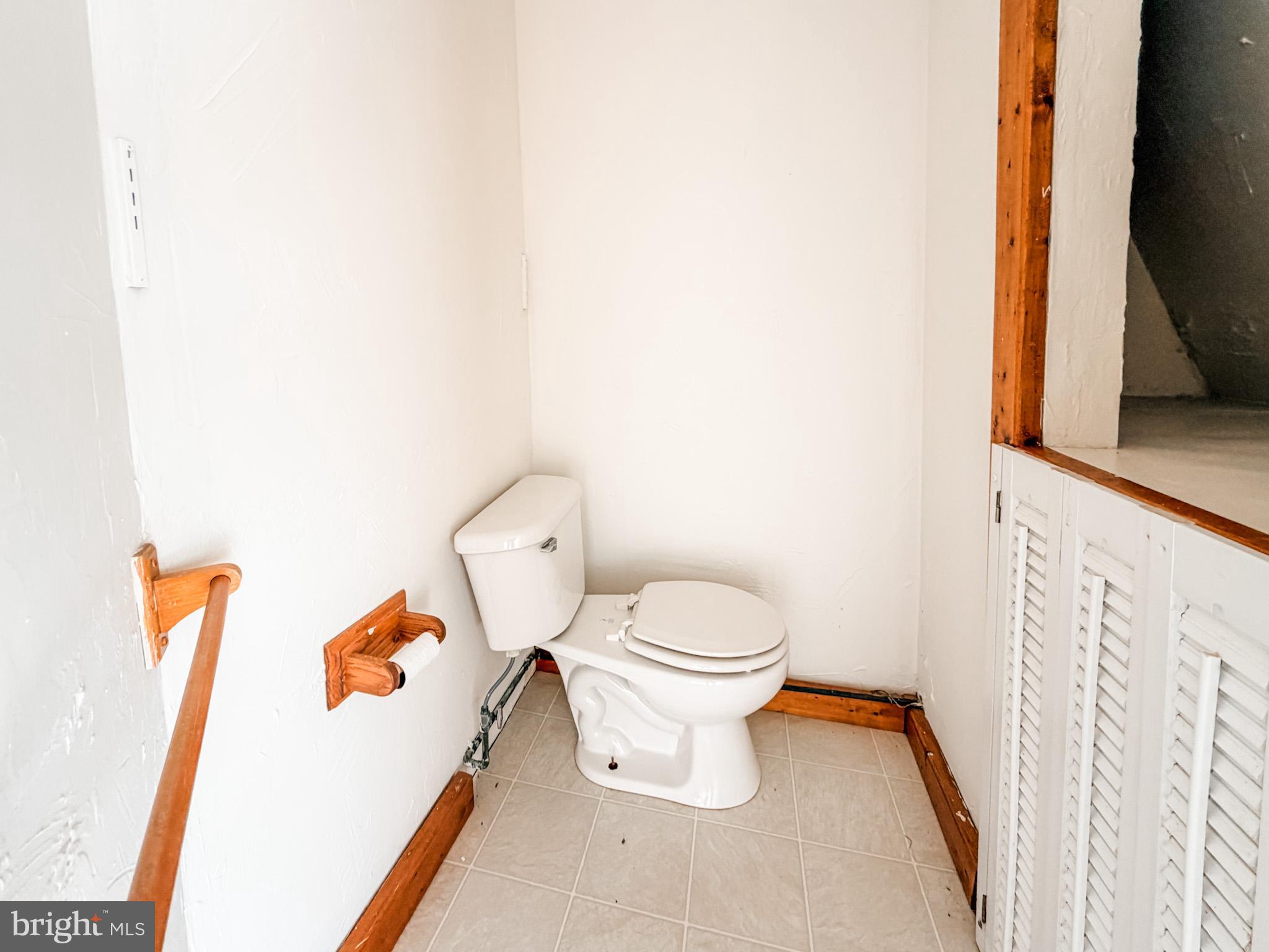7267 Benedict Avenue Benedict, MD 20612 - Photo 19 of 28 a white toilet sitting next to a bathroom sink