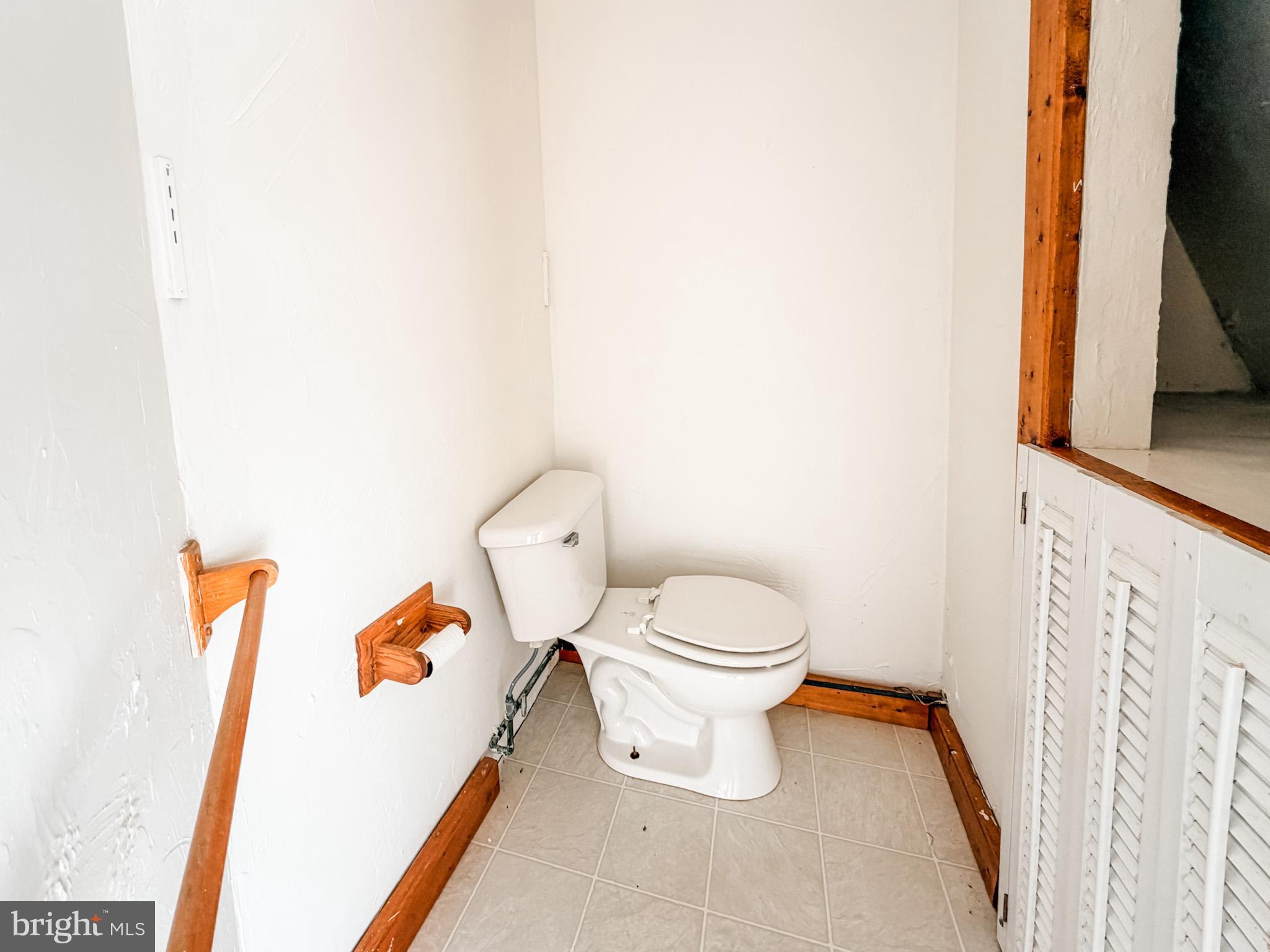 7267 Benedict Avenue Benedict, MD 20612 - Photo 20 of 28 a white toilet sitting next to a white cabinet