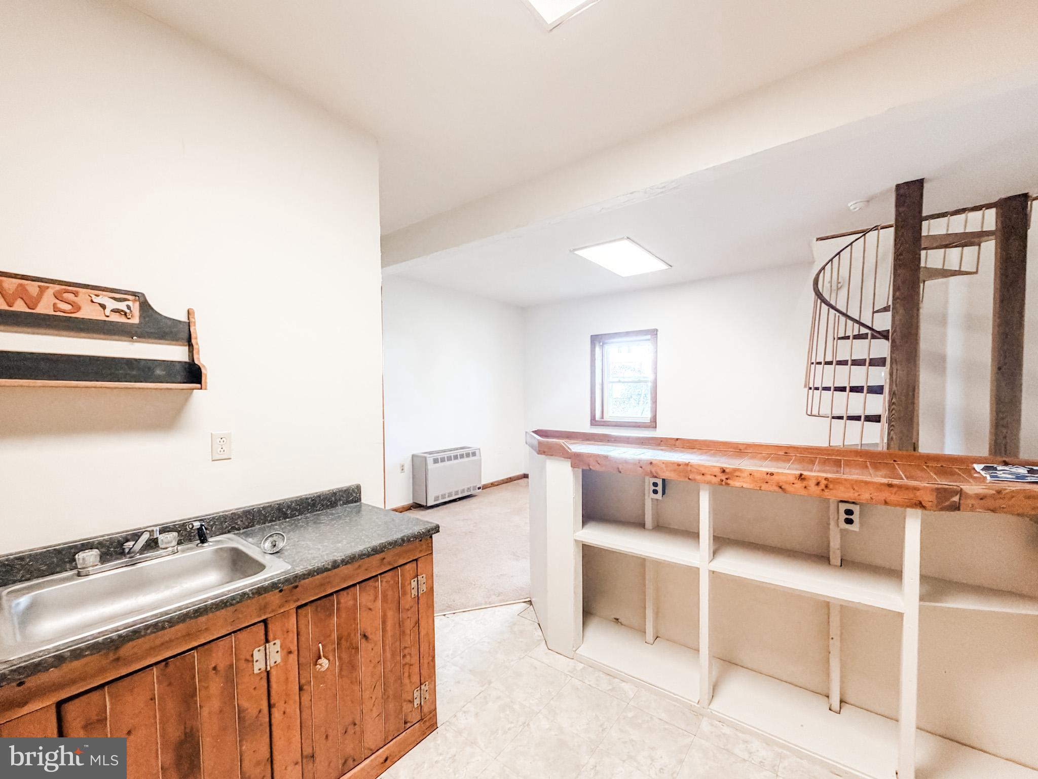7267 Benedict Avenue Benedict, MD 20612 - Photo 27 of 28 a kitchen that has a sink wooden floor and a stove