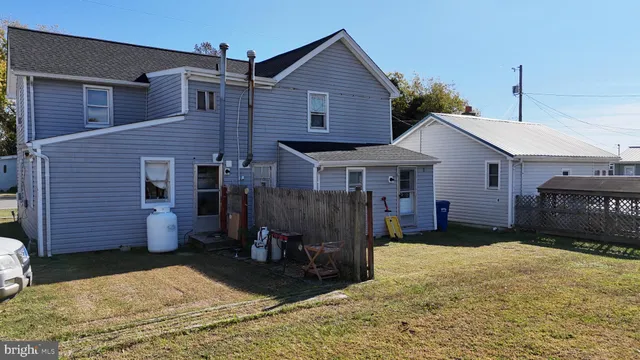 a dining room with furniture a rug and wooden floor