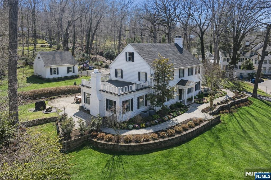 14 Old Smith Road Tenafly, NJ 07670 - Photo 2 of 50 a aerial view of a house with a yard table and chairs