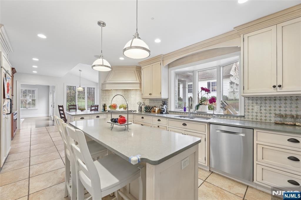 14 Old Smith Road Tenafly, NJ 07670 - Photo 21 of 50 a kitchen with kitchen island granite countertop a sink a stove cabinets and counter space