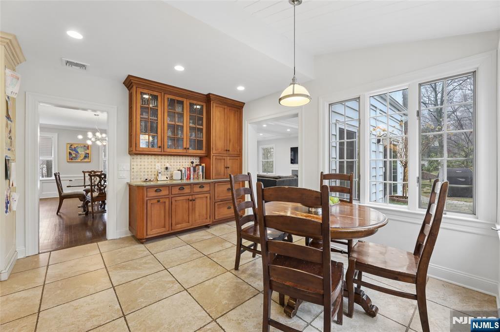 14 Old Smith Road Tenafly, NJ 07670 - Photo 23 of 50 a view of a dining room and livingroom with furniture wooden floor a chandelier