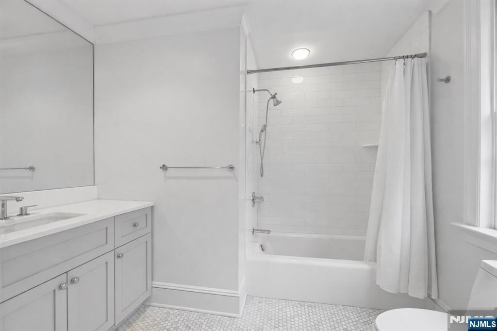 14 Old Smith Road Tenafly, NJ 07670 - Photo 40 of 50 a bathroom with a bathtub shower sink vanity and toilet