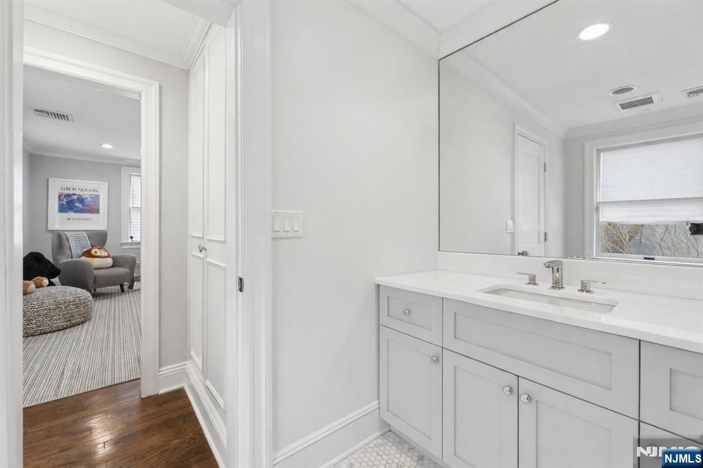 14 Old Smith Road Tenafly, NJ 07670 - Photo 41 of 50 a en suite bathroom with a sink and mirror