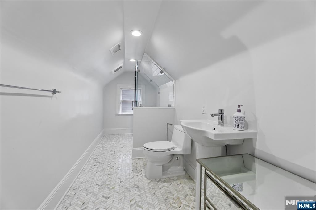 14 Old Smith Road Tenafly, NJ 07670 - Photo 46 of 50 a bathroom with a sink a toilet and a mirror