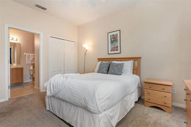 a bedroom with a bed and cabinet