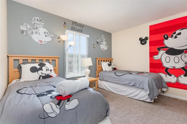 a bedroom with two bed and a couch