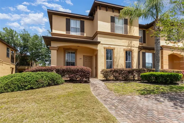 a front view of a brick house with a yard
