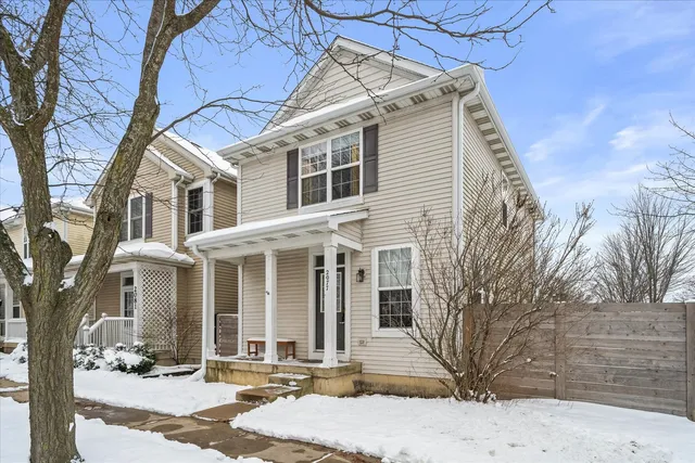 a front view of a building with a yard covered in snow