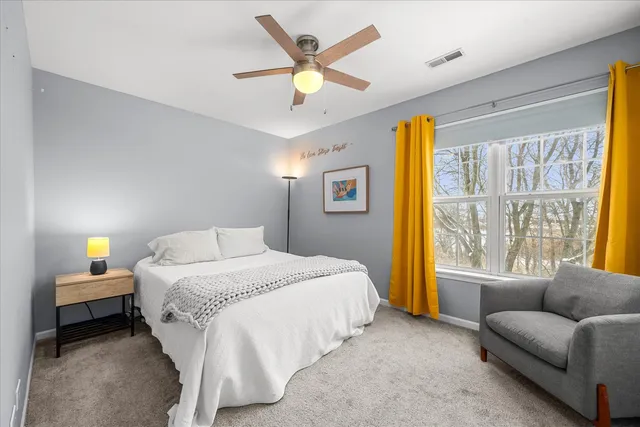 a bedroom with a bed couch and window