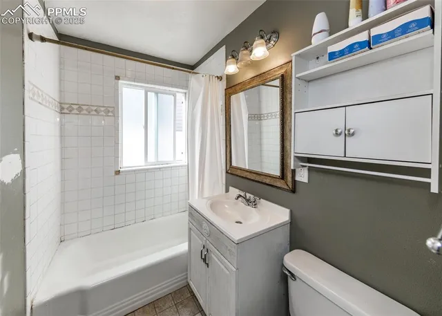 a kitchen with granite countertop a stove and a wooden floor