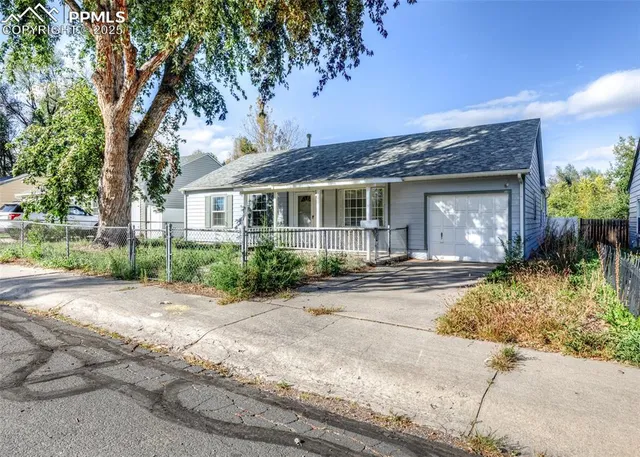 a front view of a house with a yard and a garage