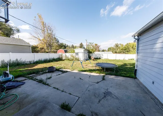 a view of a backyard with plants and outdoor seating