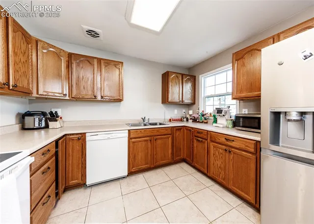 a kitchen that has a sink cabinets and window