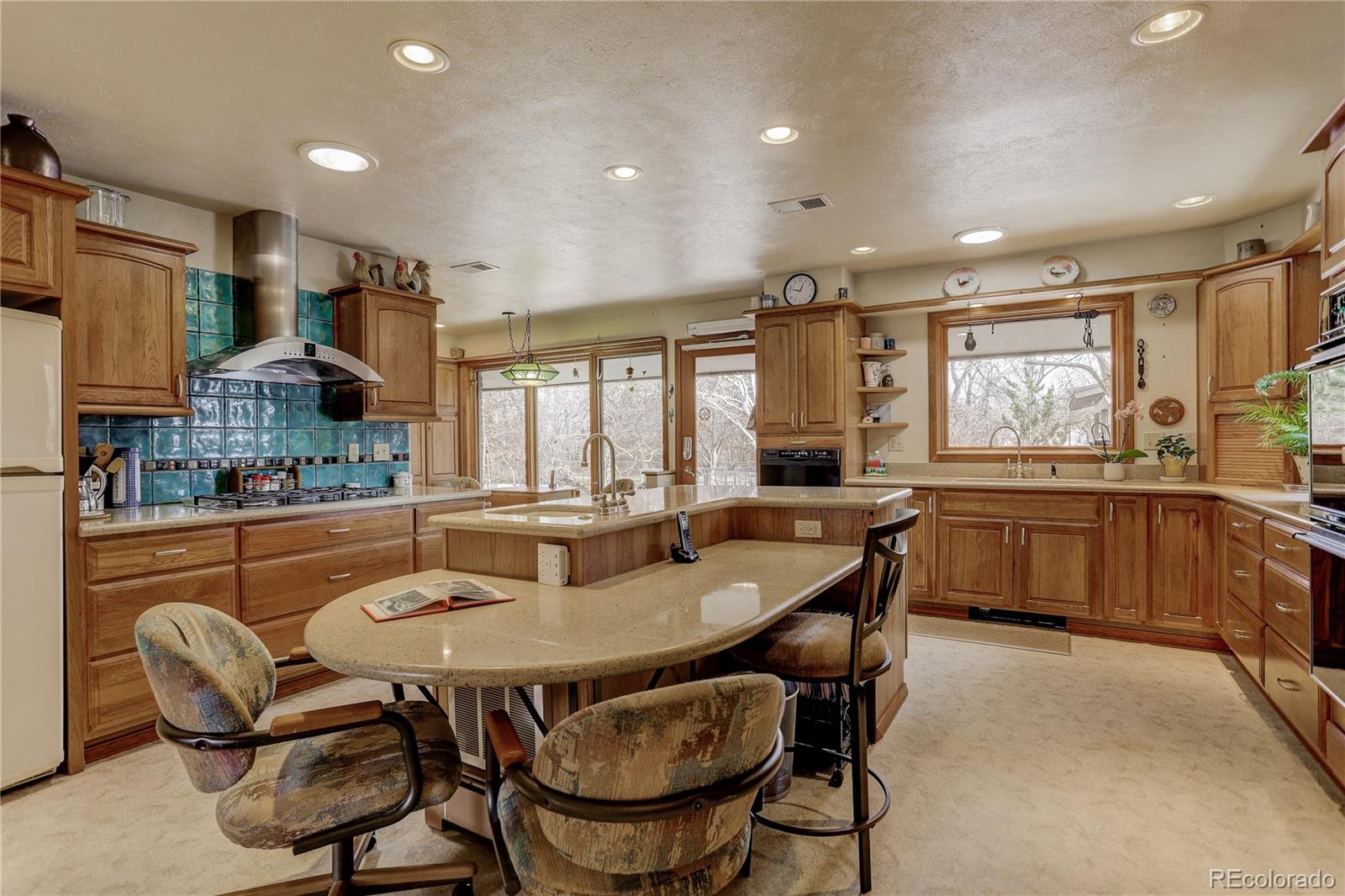 1310 Old Tale Road Boulder, CO 80303 - Photo 7 of 23 a dining room with stainless steel appliances a dining table and chairs